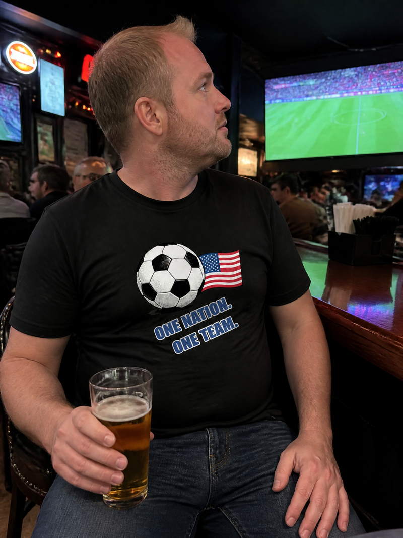 Man wearing a custom soccer T-shirt while watching a game at a sports bar