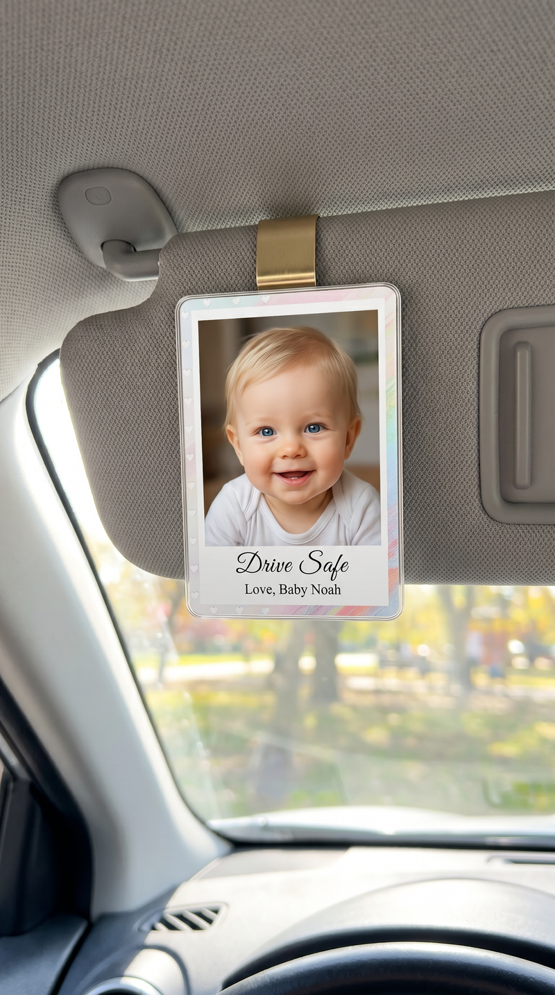 Personalized baby photo ornament hanging from the back of a car seat