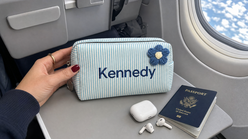 Personalized blue corduroy makeup bag with custom name Kennedy inside a car