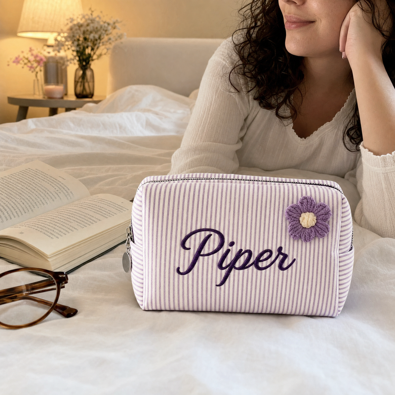Personalized lavender corduroy pouch with custom name Piper on a bed