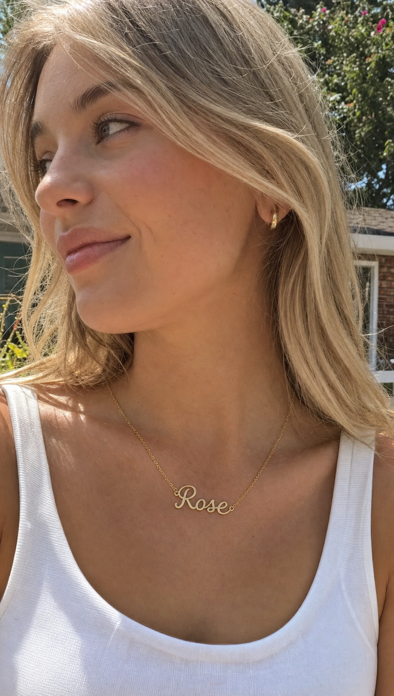 Woman wearing a personalized name necklace with Rose pendant