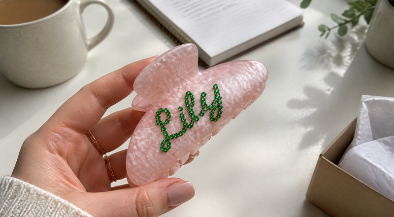 Close-up of a pink personalized bow-shaped accessory with custom name Lily
