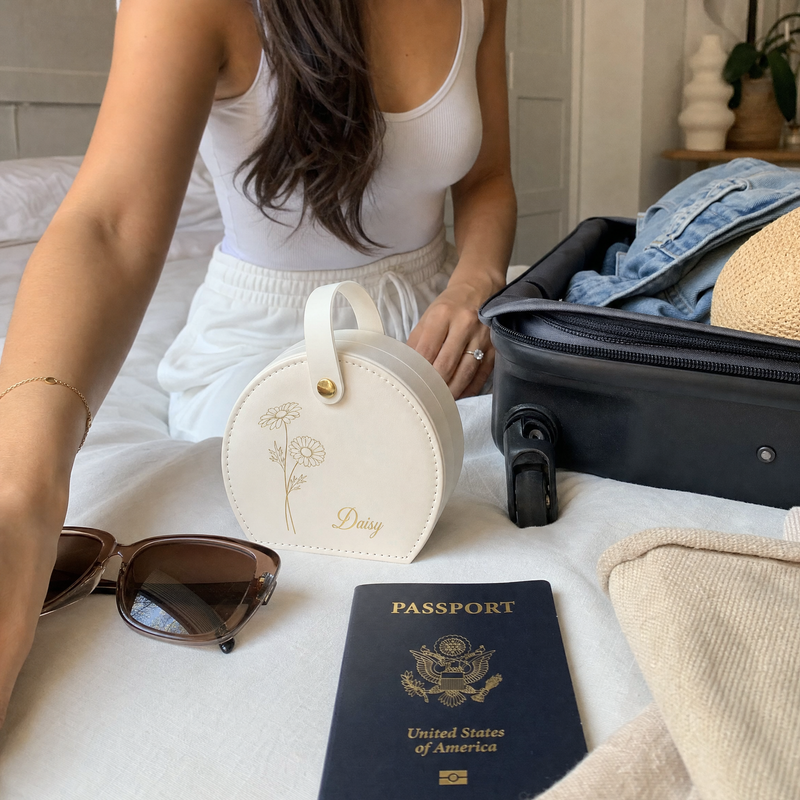Personalized white travel pouch with custom design arranged with sunglasses and passport